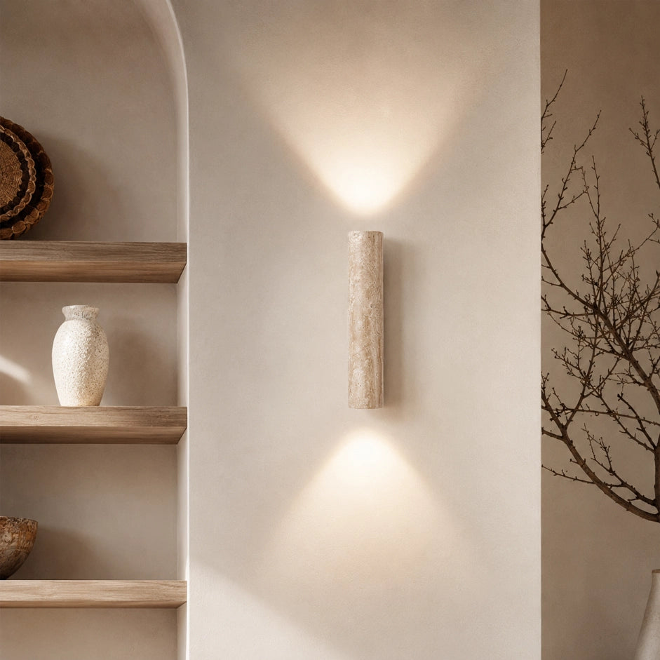 The Strata travertine wall sconce lit up and down