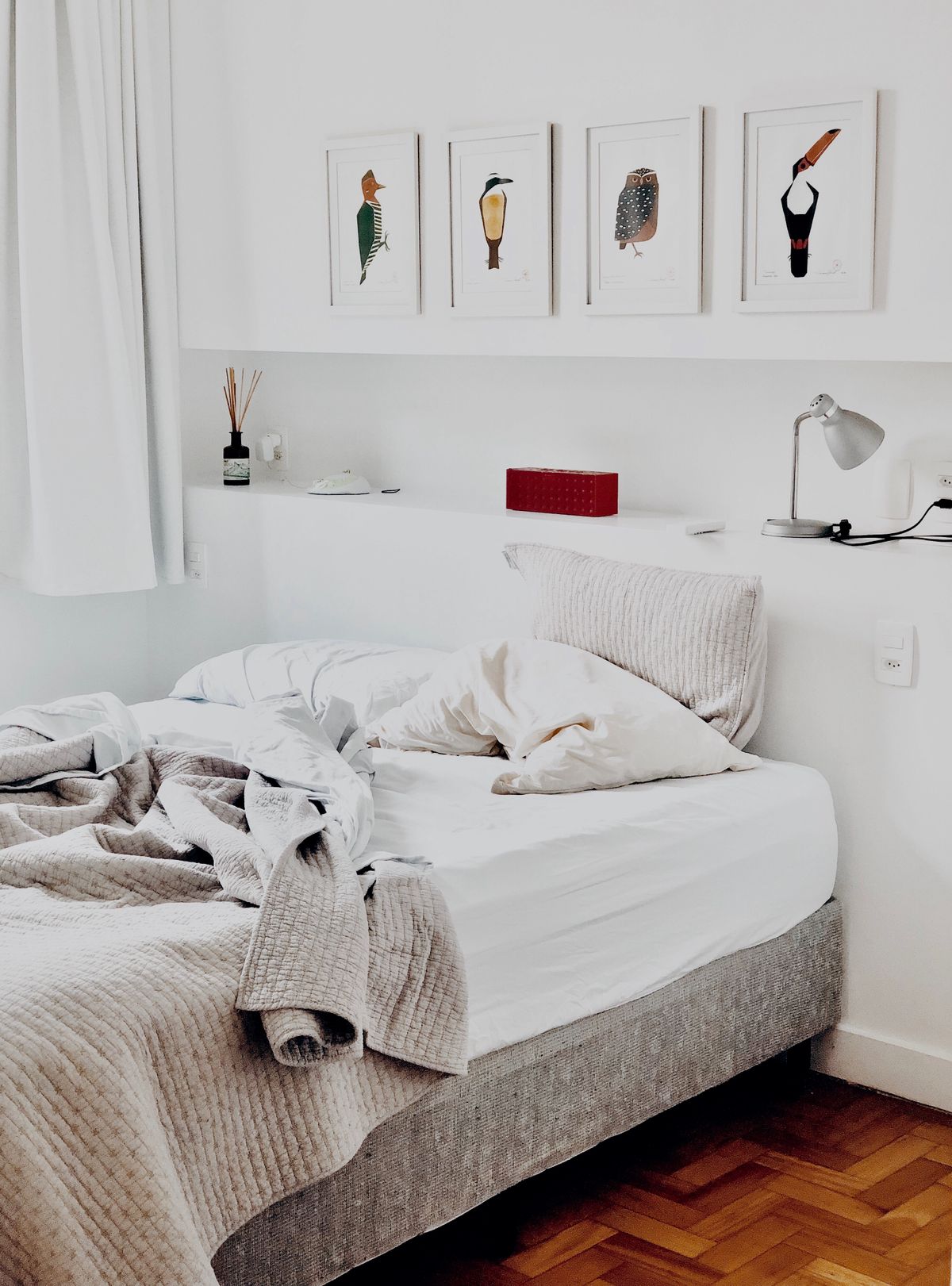 Calm bedroom with wall lights either side of the bed