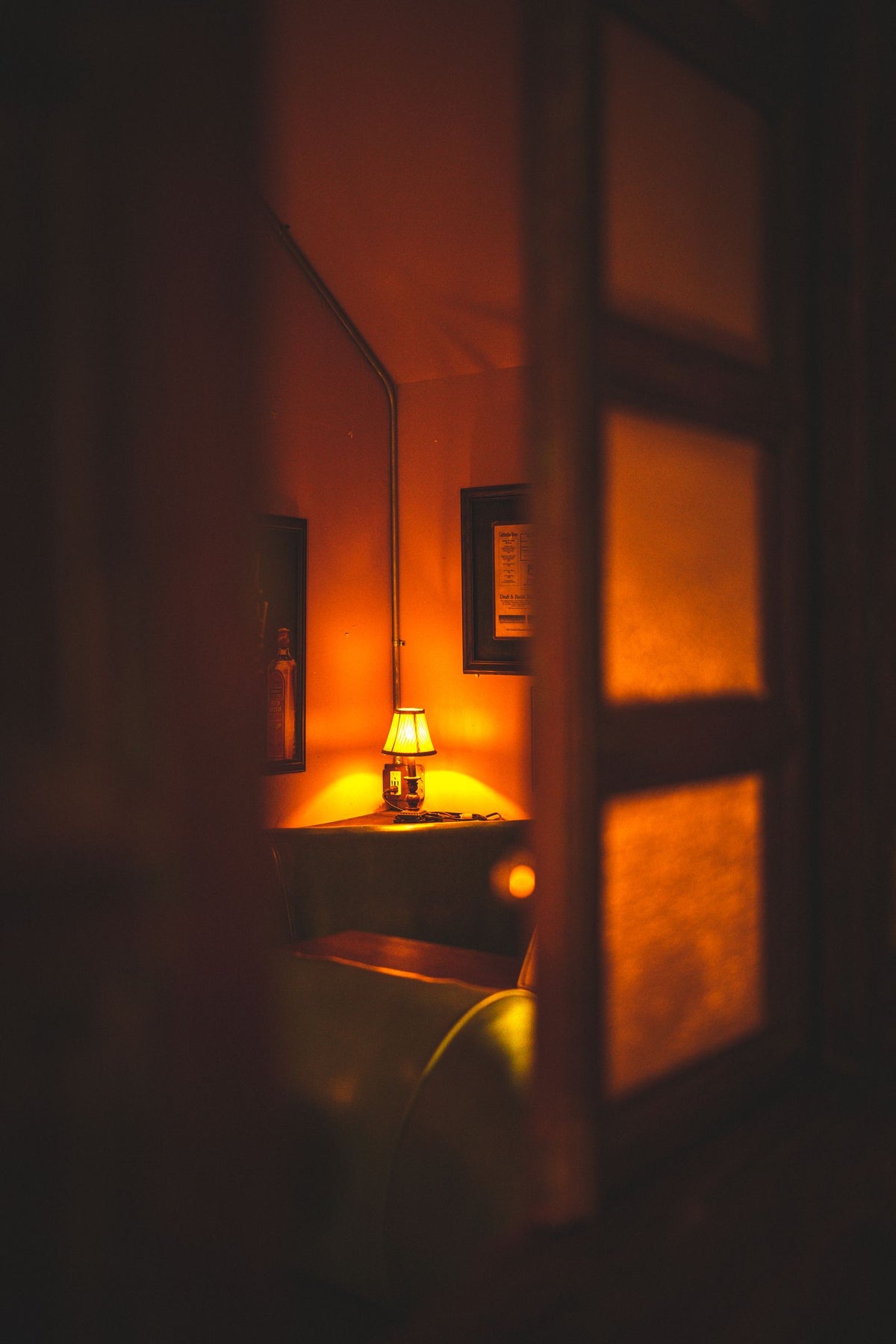 Lamp glowing warm yellow light in a dark room