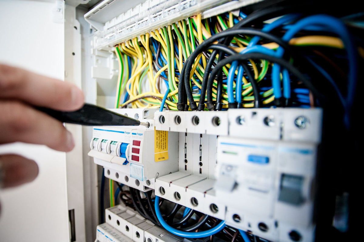 Electrician working on electrical wiring - wall light installation cost