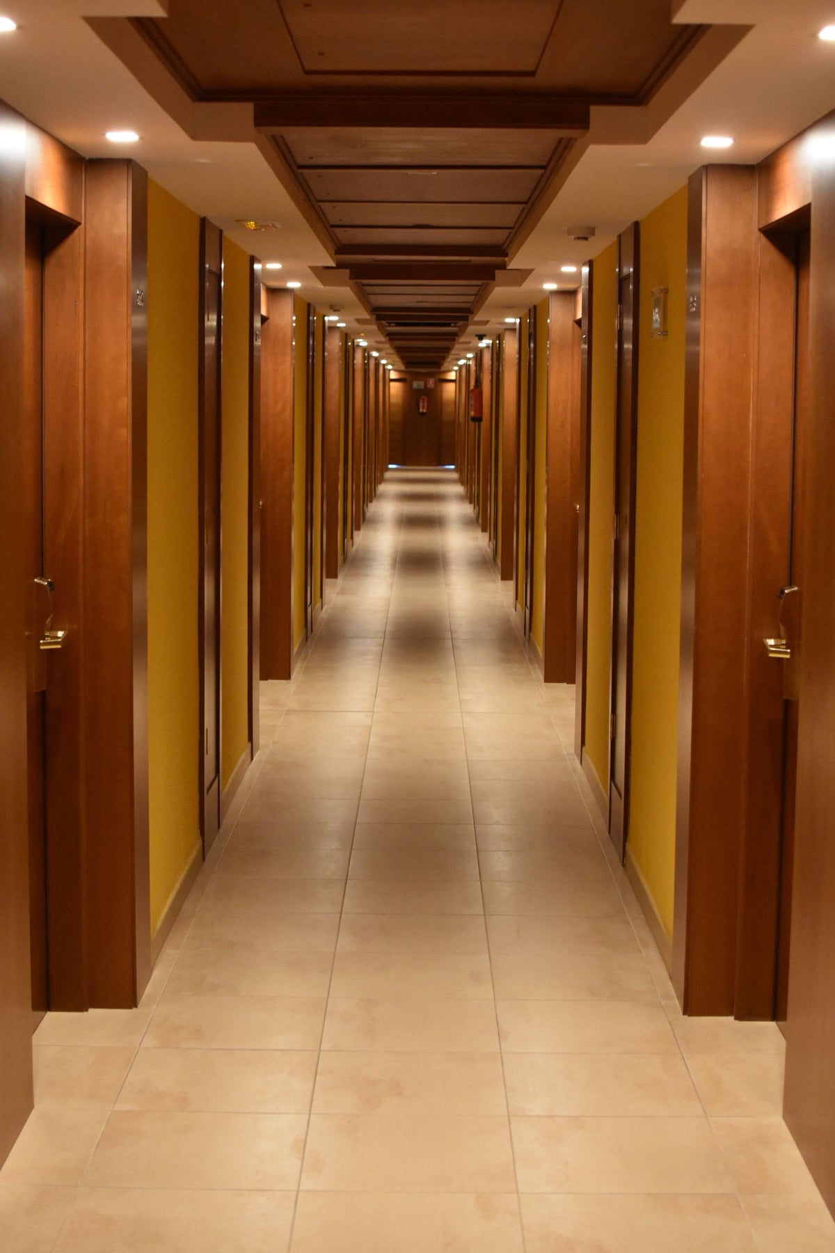 Warm wall lights along a hallway corridor