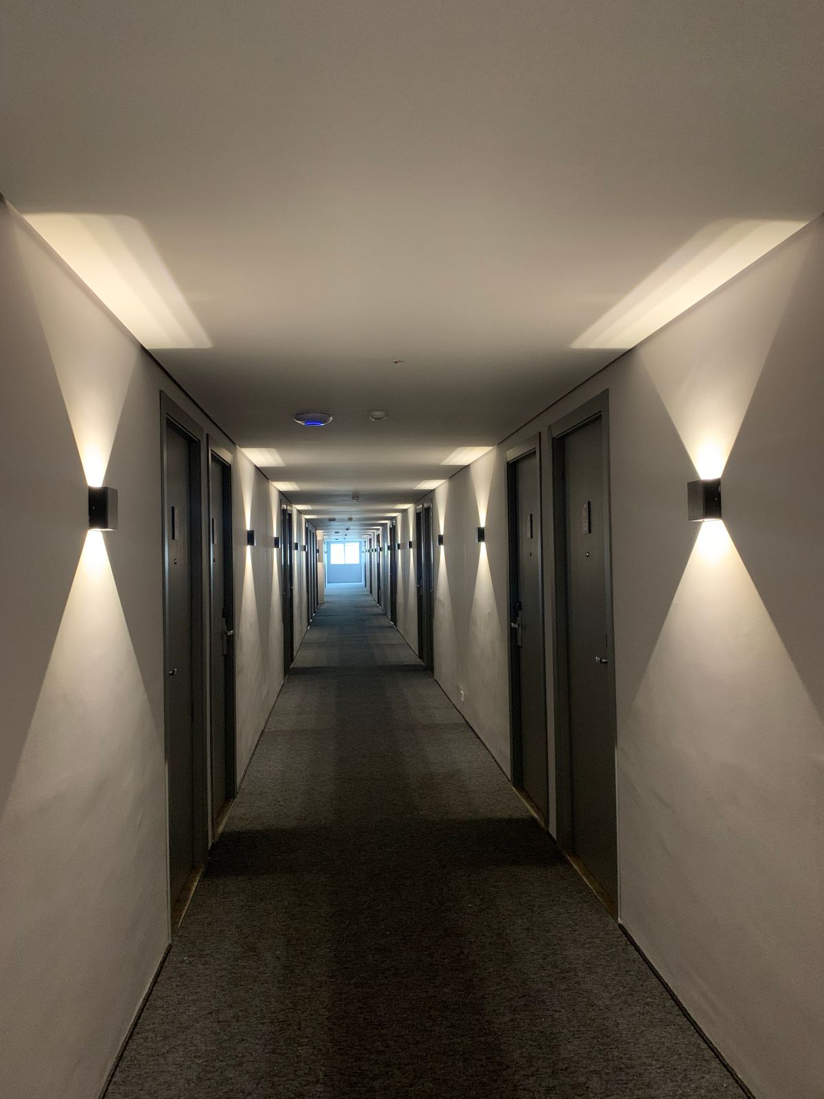 Hallway with evenly spaced wall lights