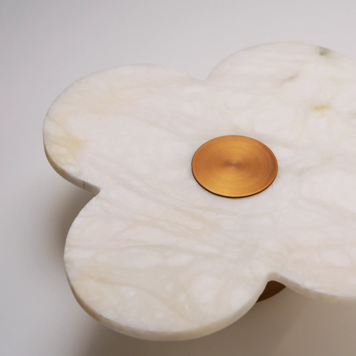 Close-up of hand-carved alabaster petals on The Petalo sconce