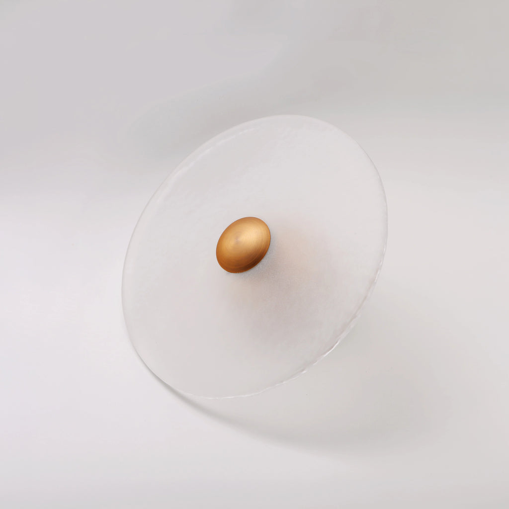 The Orbis wall sconce in brass finish, unlit