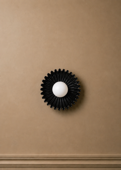 The Solara ceramic sunburst wall sconce styled in modern interior
