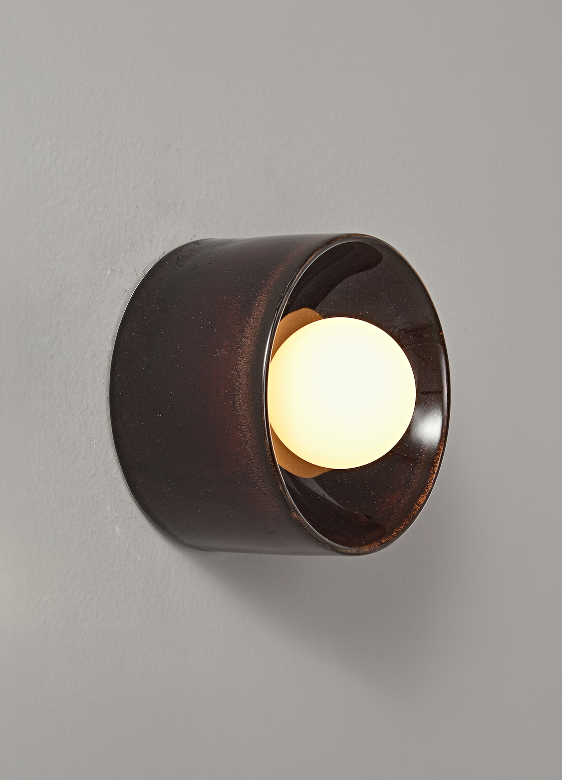 The Volta ceramic wall sconce in dark brown finish