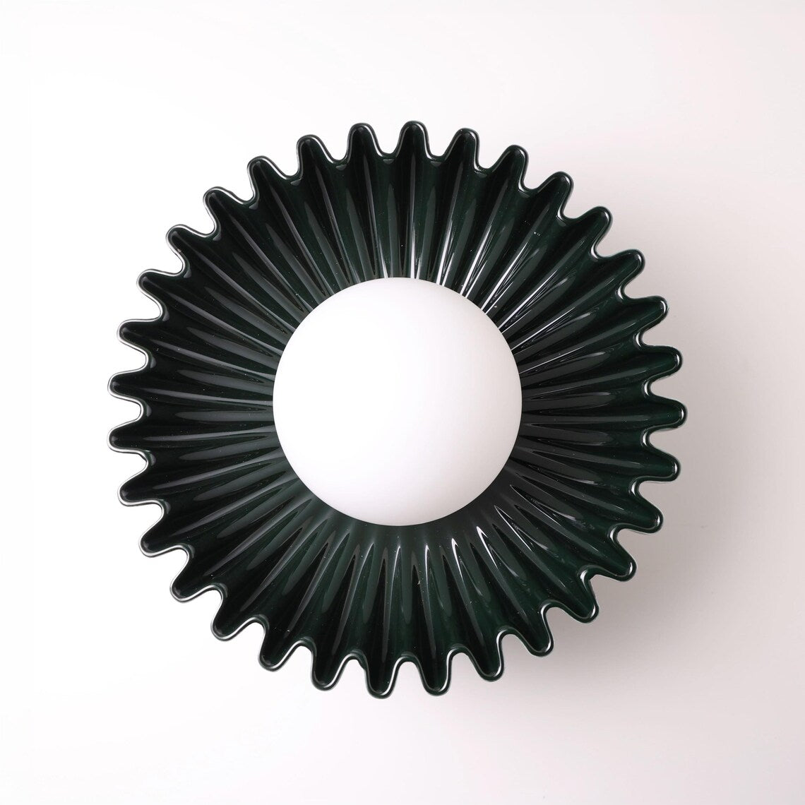 The Solara dark green ceramic wall sconce, front view