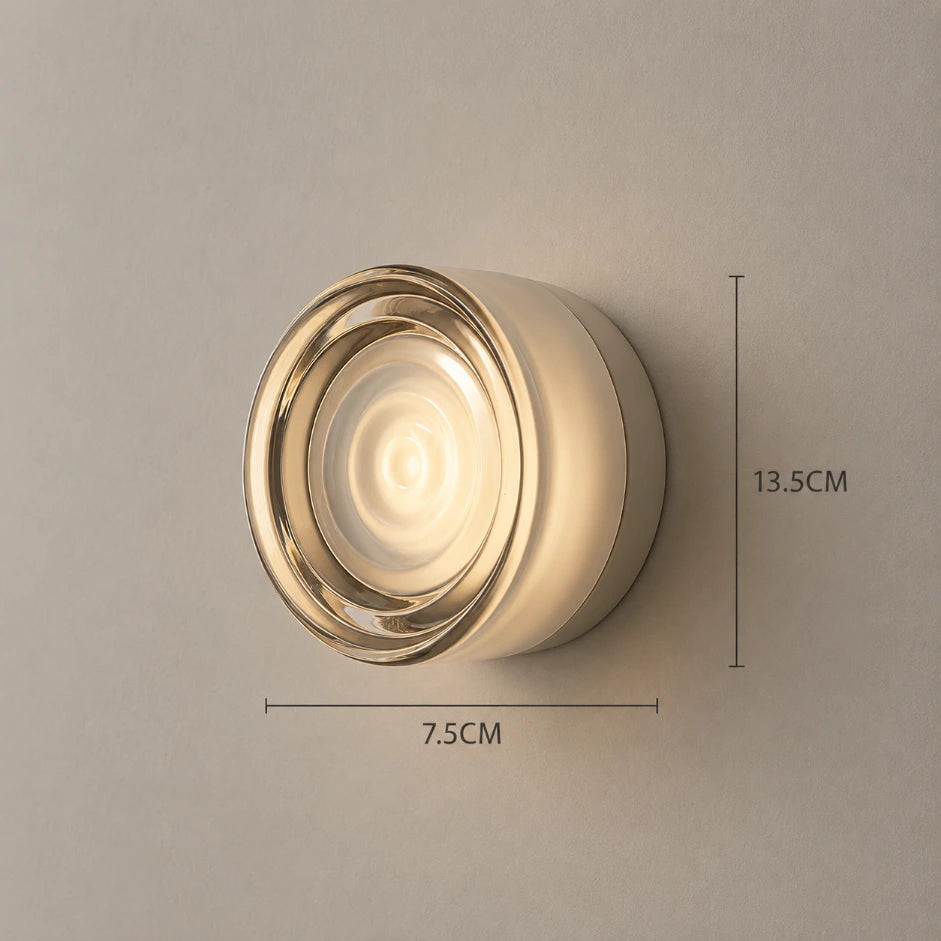 The Orb outdoor LED wall sconce glowing on exterior wall