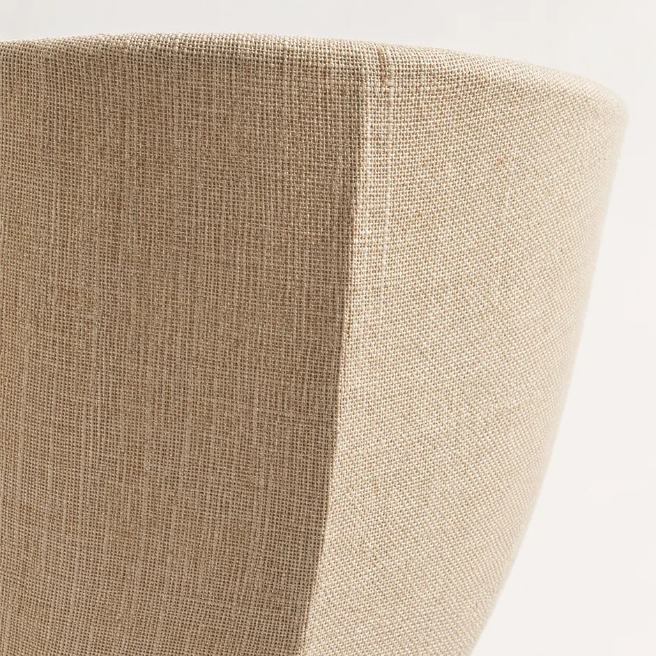 The Veil linen wall sconce lit with soft diffused glow