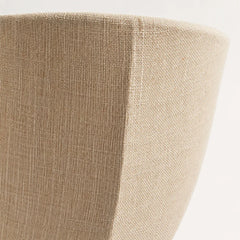 The Veil linen wall sconce lit with soft diffused glow