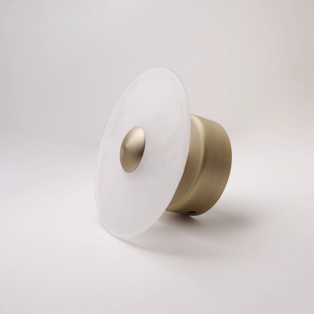 The Orbis frosted glass wall sconce with bronze dome