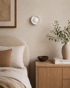 The Volta ceramic wall sconce with glass globe close-up