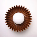 The Solara ceramic sunburst wall sconce in brown, front view