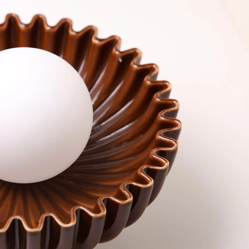 The Solara brown ceramic sunburst sconce side view
