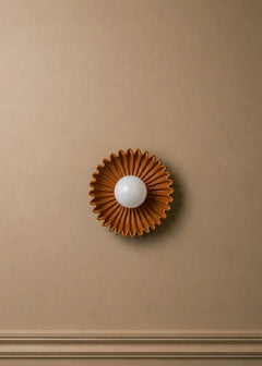 The Solara ceramic sunburst wall sconce with opal glass globe