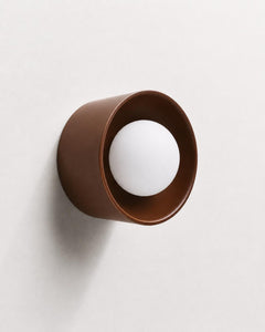 The Volta ceramic cylinder wall sconce with frosted glass globe